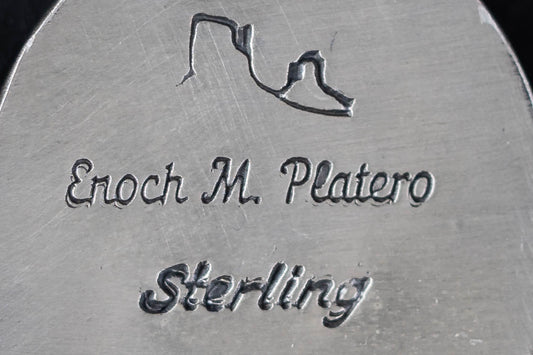 stamps of 'Enoch Michael' and 'sterling' with a monument valley pictograph
